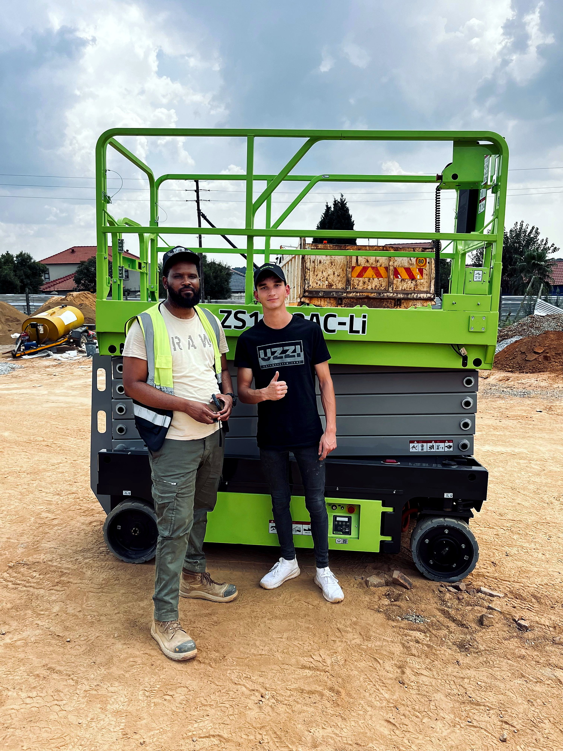 Morne and a customer standing in front of a green lift machine